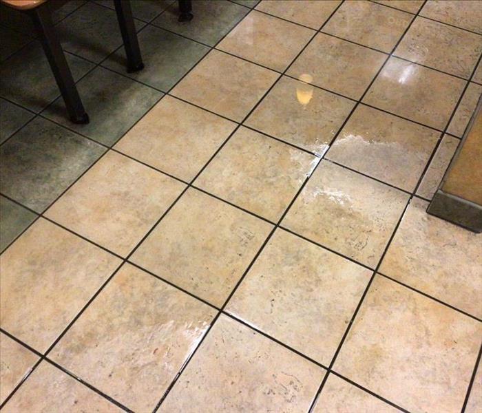 Tile restaurant floor with standing water by booths