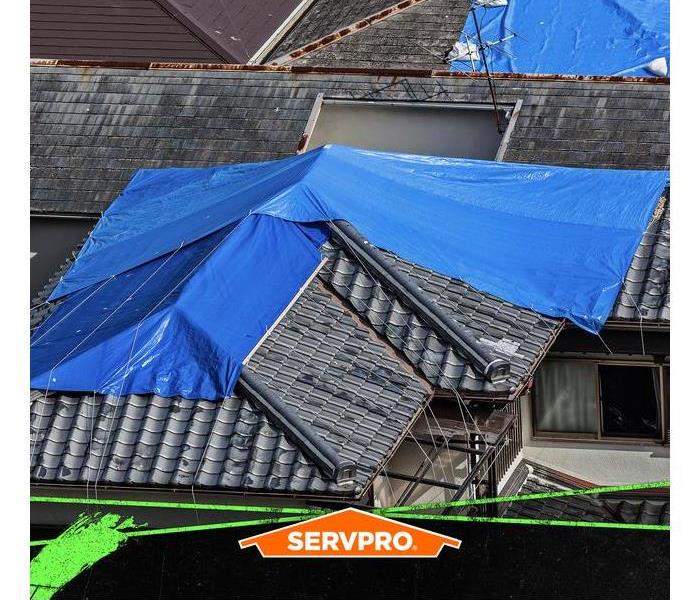 Blue tarp covering a large area of a home.